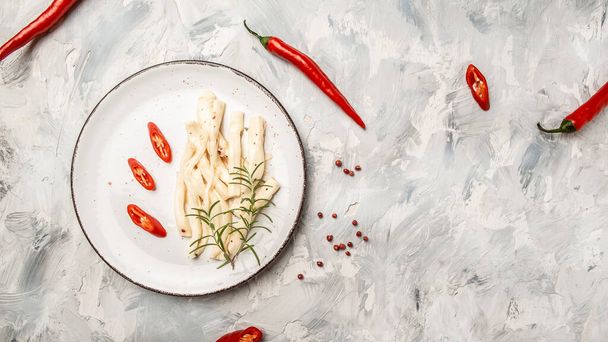 Marinated goat cheese with olive oil and hot chili peppers, Long banner format, top view. - Photo, Image