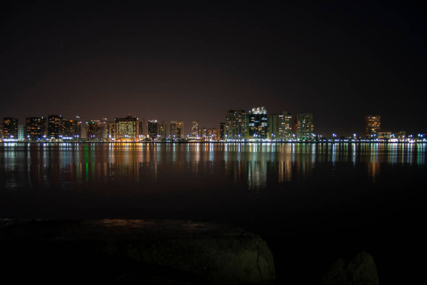 A night skyline of the Abu Dhabi Corniche taken from the large flagpole - Photo, Image