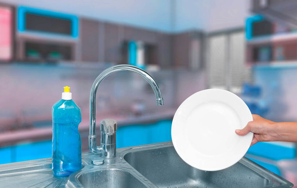 mani piatti di lavaggio con pulitore blu e mostrando un risultato pulito (piatto bianco pulito) in cucina moderna - Foto, immagini
