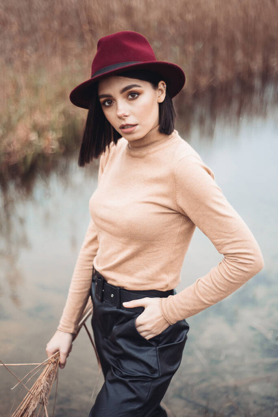Beautiful woman enjoing autumn day. Beauty and fashion. Autumn fashion and lifestyle. Pretty woman wearing warm autumn clothes, hat and yellow scarf. Autumn mood. Fashionable woman outdoors. - Zdjęcie, obraz