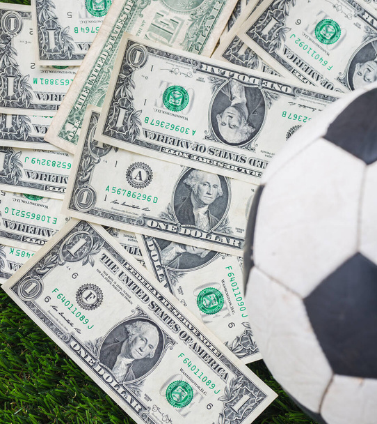  pallone da calcio con dollaro bolletta su sfondo erba - Foto, immagini