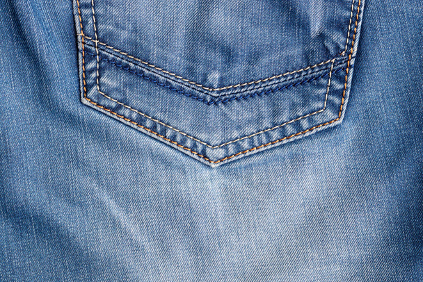 Blue jeans fabric texture. Distressed denim with back pocket background - Photo, Image