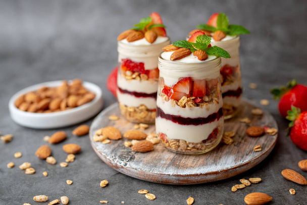 Strawberry Dessert Jar, yogurt fruit parfait topped with almonds - Фото, зображення