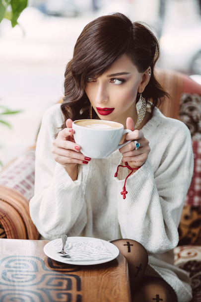 Young girl drinking coffee in a trendy cafe - Photo, image