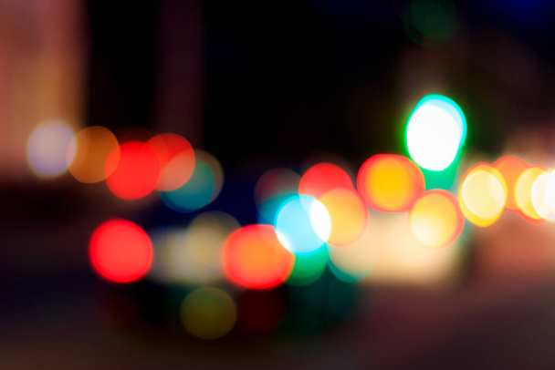 Blurred lights of headlights of cars and lanterns in the night city. Abstract bright bokeh. - 写真・画像