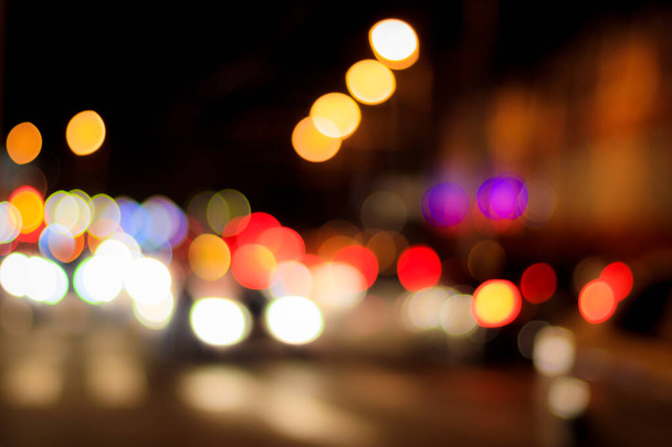 Blurred lights of headlights of cars and lanterns in the night city. Abstract bright bokeh. - Photo, Image