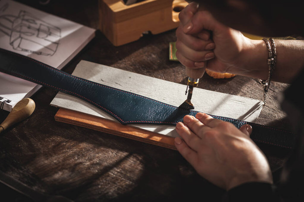 Artesano bolso de cuero en el trabajo en un taller vintage. Concepto de pequeña empresa. - Foto, Imagen