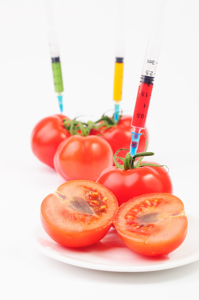 Syringes sticking out of tomatoes - Photo, Image
