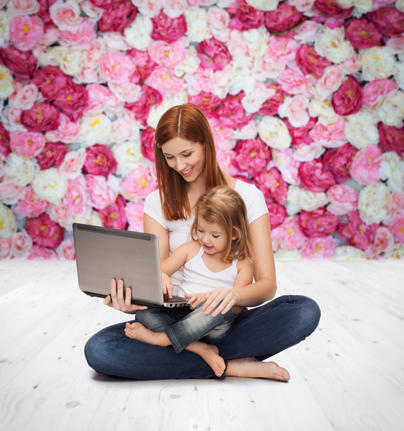 Happy mother with adorable little girl and laptop - Foto, afbeelding