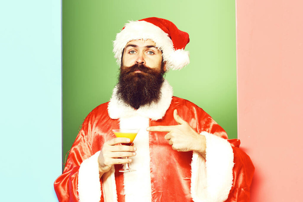 serious bearded santa claus man on colorful studio background. - Foto, imagen