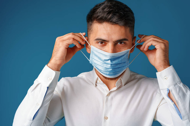 Handsome mixed-race man wearing medical face mask - Photo, Image