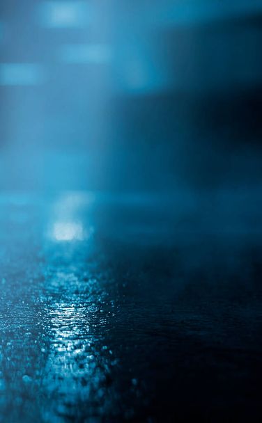 Dark street, wet asphalt, reflections of rays in the water. Abstract dark blue background, smoke, smog. Empty dark scene, neon light, spotlights. Concrete floor - Photo, Image