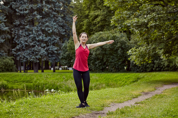 Energy lady makes yoga in public park. - Φωτογραφία, εικόνα
