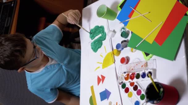 Child with a Brush in Hand Paints Sun with Yellow Paint on White Sheet of Paper - Footage, Video