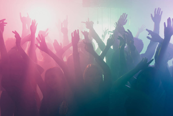 Photo of big company many people crazy atmosphere dance floor neon bright spotlight modern club indoors - Фото, изображение