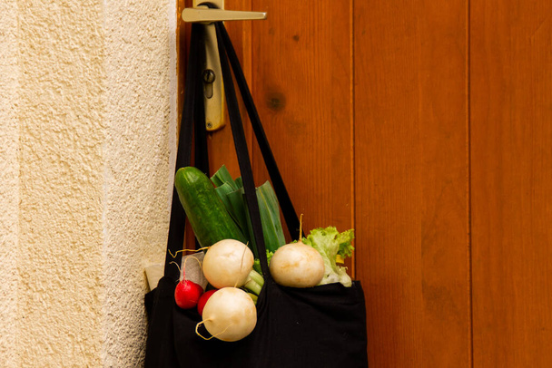Мешок с едой у дверей дома. Пожертвование на доставку еды - Фото, изображение