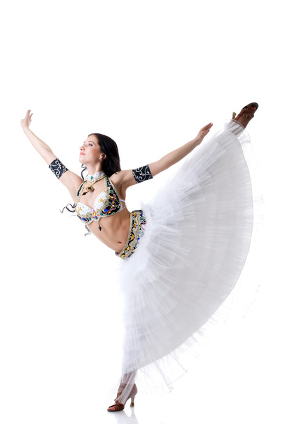 Smiling belly dancer gracefully posing in studio - Фото, изображение