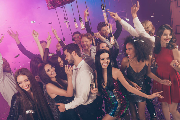 Photo of group carefree crazy people dance flirt raise hands wear stylish outfit modern club indoors - Fotografie, Obrázek