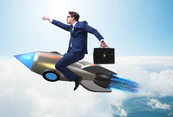 Businessman flying on rocket in business concept - Photo, Image