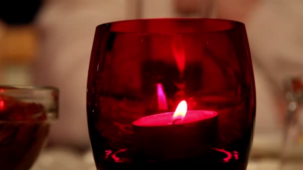 A candlelight inside a red glass - Video