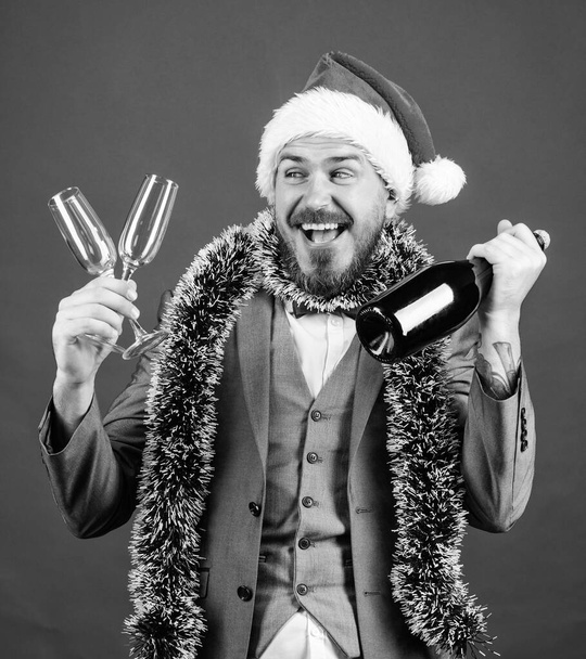 Lets drink champagne. Boss santa hat tinsel celebrate new year or christmas. Join christmas celebration. Christmas party invitation. Man bearded hipster santa hold bottle. Corporate christmas party - Fotoğraf, Görsel