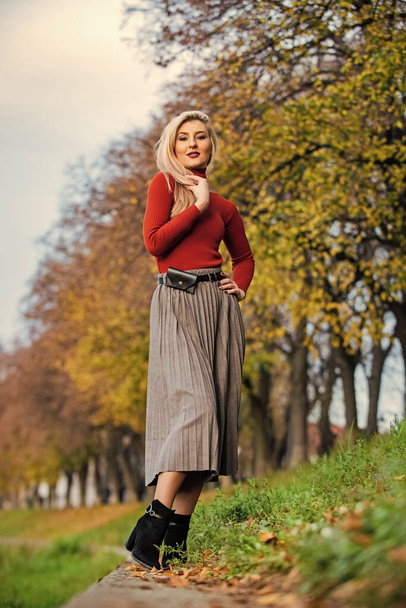 the pleated midi. woman warm autumn skirt outdoor. relax while walking. enjoy casual day. Clothing features pleats. must-have skirt. trendy girl wear corrugated skirt. pleated skirt collection - Foto, immagini