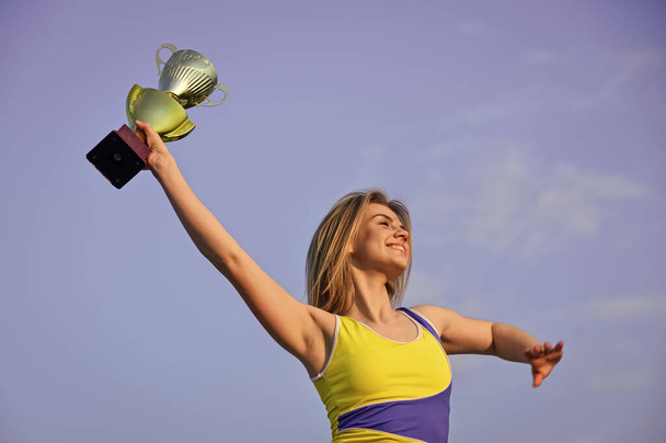 Conception of victory in the competition. happy woman with gold champion cup. successful prize winner. Feeling free and confident. Declaring the winner. girl celebrates victory in competition - 写真・画像