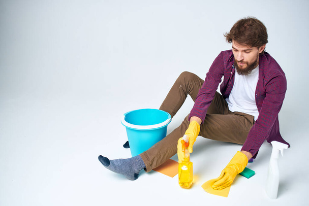cleaner lying on the floor with a bucket of detergent cleaning service rendering Professional - Foto, immagini