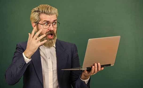 School lifehack. Teacher wear eyeglasses hold laptop surfing internet. Lot of information. Bearded man modern laptop surfing internet. Interesting information. Provide accurate current information - Foto, immagini