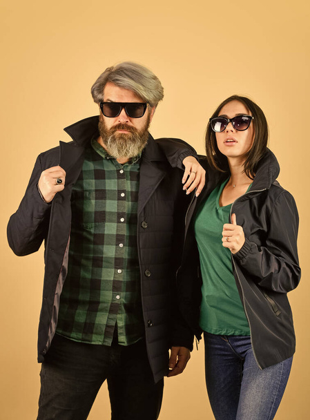 Saint Patricks day. Bearded man with dyed hair checkered shirt and girl in sunglasses. Fashion couple in love. Fashionable couple posing. Enjoying spring time together. Street style. Hipster couple - 写真・画像