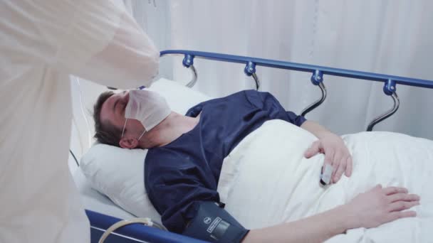 Pielęgniarka Pomiar Coronavirus Pacjenci Temperatura i prowadzący lekarz zanotowanie to w dół - Materiał filmowy, wideo