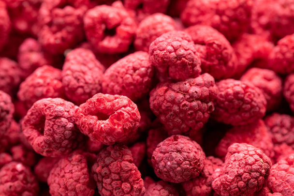 Macro shot of freeze dried organic raspberries, natural fresh fruit background - Photo, Image