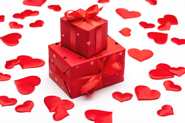 Beloved's gift for Valentine's Day. Box packed in red paper with red satin ribbon on light background. - Valokuva, kuva