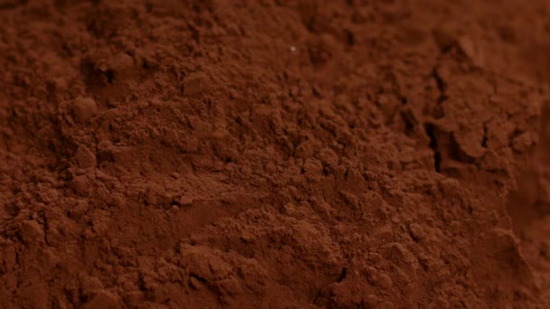 Chocolate truffle candy falling down in cocoa powder making splash, slow motion - Footage, Video