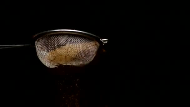 Sprinkling kaneel koffie chocolade cacao poeder in slow mo, zwarte achtergrond - Video