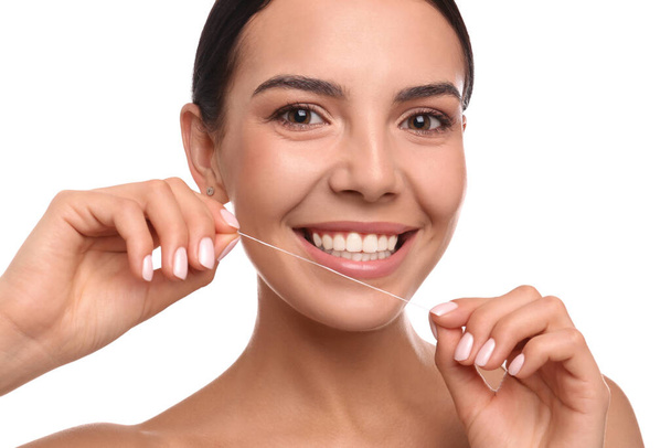 若い女性が白い背景に歯をはいている。化粧品歯科 - 写真・画像