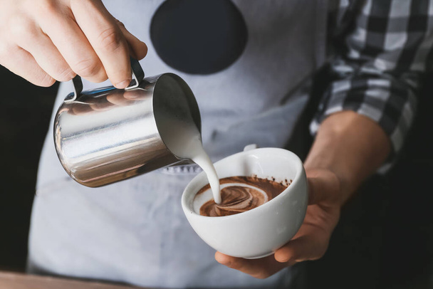 Barista making hot coffee in cafe, closeup - Фото, зображення
