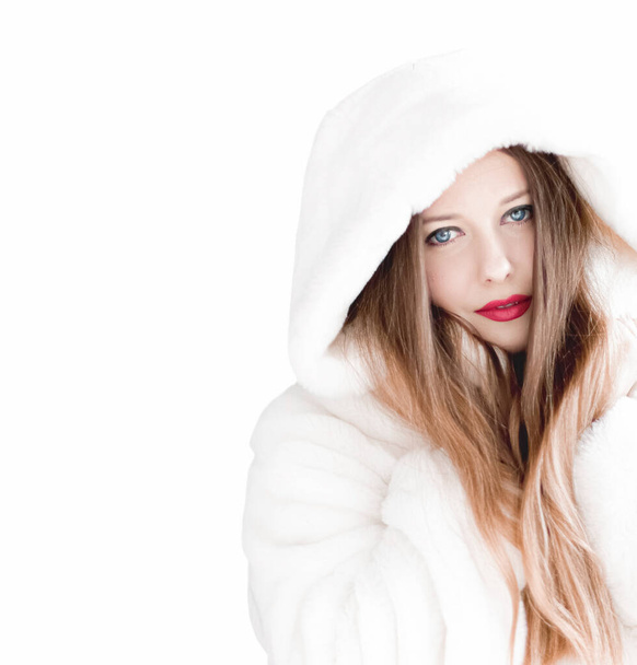 Young woman in fluffy fur coat with hood wrap, warm winter clothing for fashion and Christmas holidays - Φωτογραφία, εικόνα