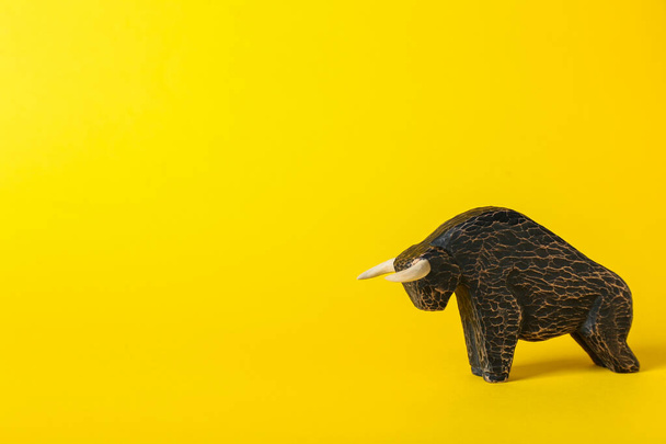 Figurine of bull as symbol of year 2021 on color background - Foto, immagini