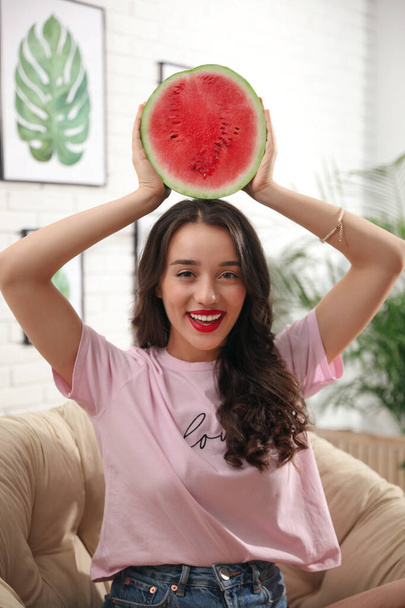 Beautiful young woman with watermelon at home - Photo, image