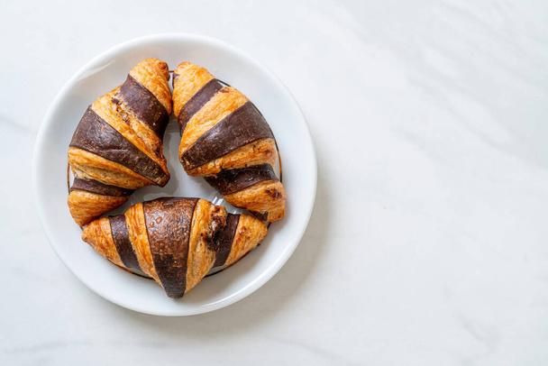 fresh croissant with chocolate on plate - Foto, Bild