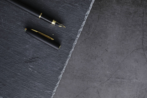 Office supplies on the table. A fountain pen. Business pen in the office on stone surface. - Foto, Bild