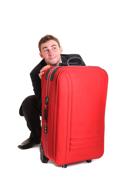 αστεία επιχείρηση άνθρωπος που κρύβονται πίσω από το κόκκινο αποσκευών - Φωτογραφία, εικόνα