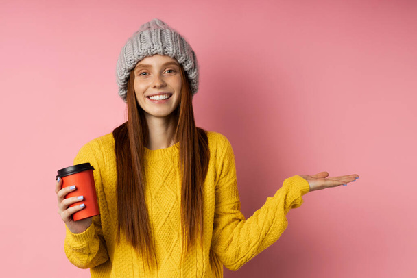 Redhead woman holding disposable cup of coffee - Foto, Imagem