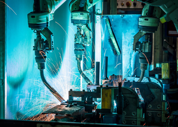 welding robots represent the movement in the automotive parts industry - Photo, Image