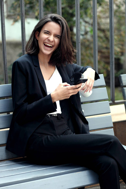Young woman talking on mobile phone outdoors - Valokuva, kuva