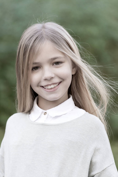 Girl with blond long hair smile on natural landscape - Foto, afbeelding