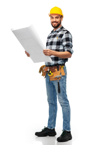 male worker or builder in helmet with blueprint - Fotó, kép