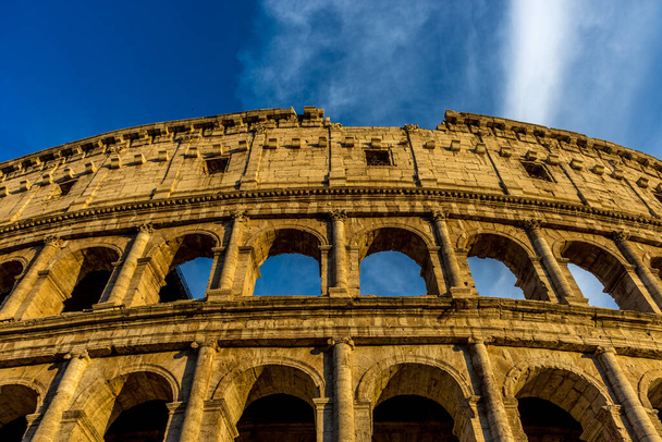 Golden sunset at the Great Roman Colosseum (Coliseum, Colosseo), also known as the Flavian Amphitheatre. Famous world landmark. Scenic urban landscape. - Photo, Image