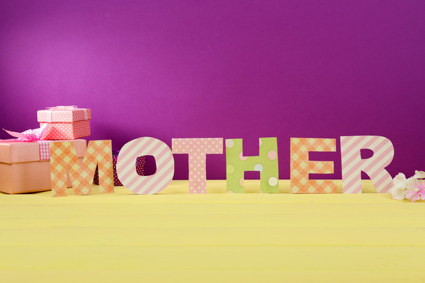 Mother- lettering of handmade paper letters on purple background - Foto, immagini